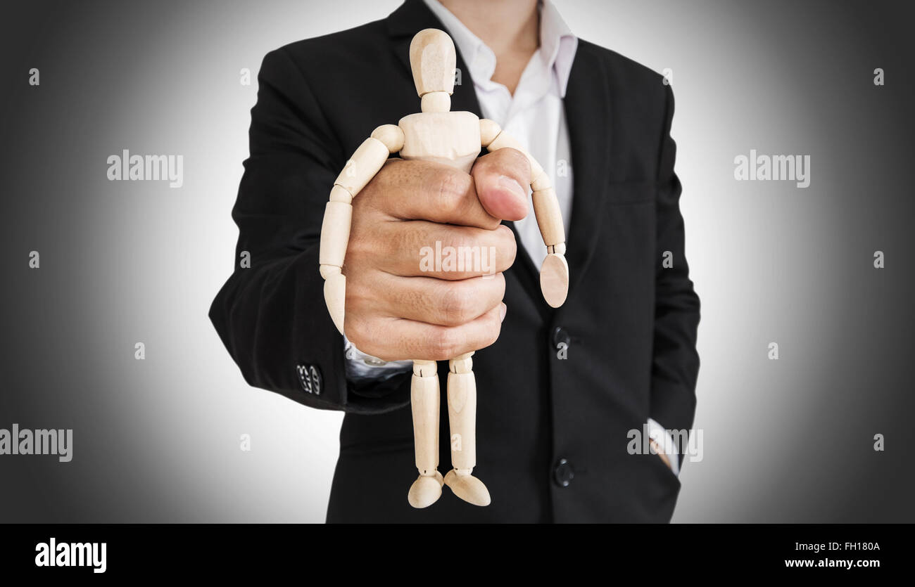 Businessman holding wooden figure, abstract concept Stock Photo