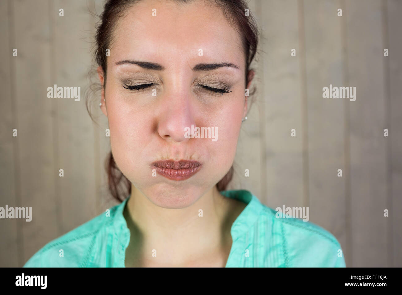 Closeup of woman with eyes closed while making face Stock Photo Alamy