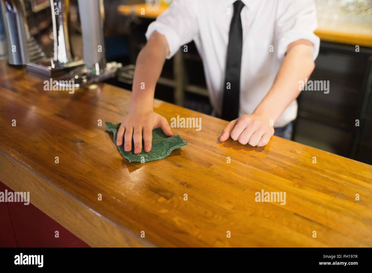 Bartender cleaning bar counter Stock Photo Alamy