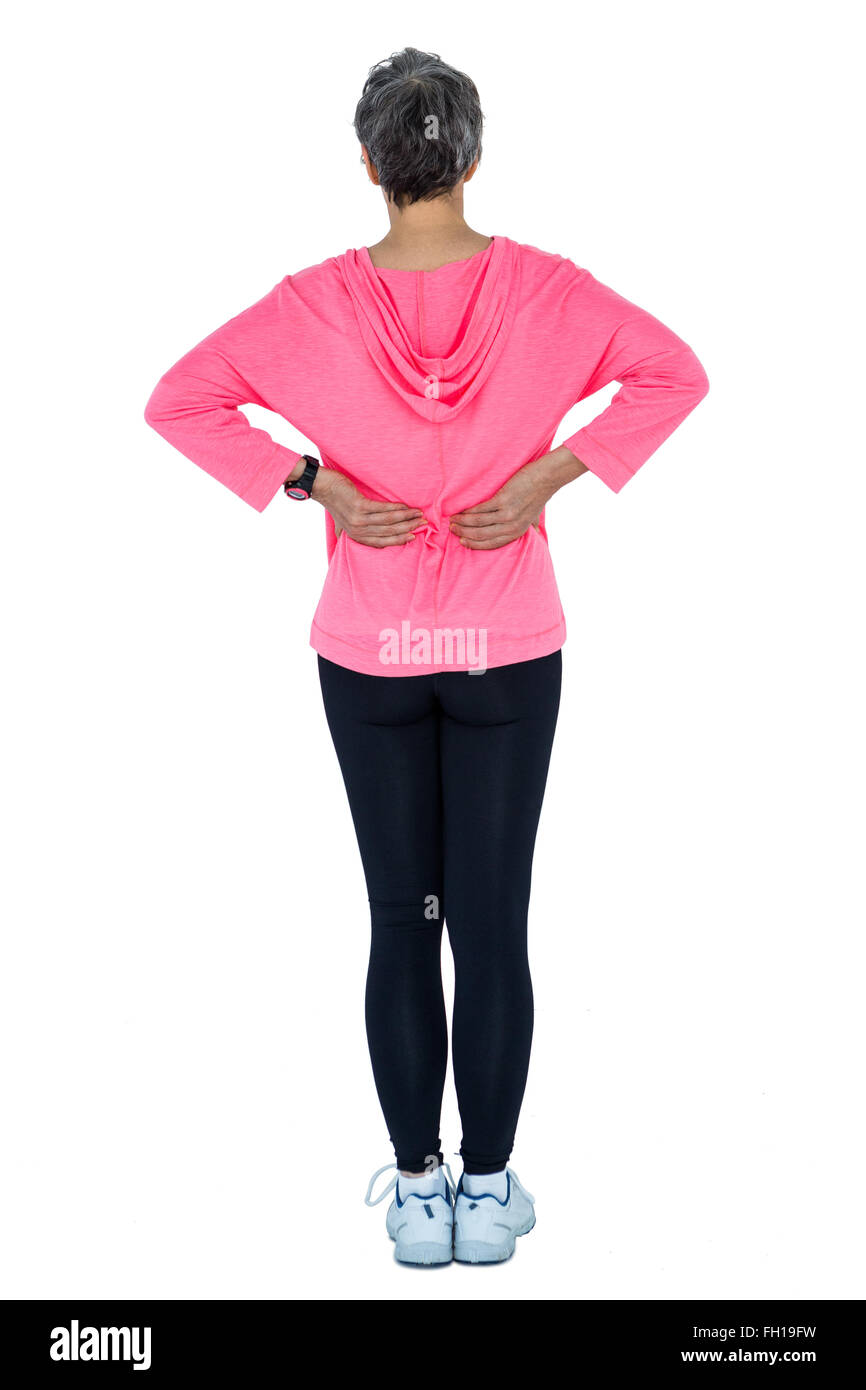 Woman in sportswear massaging back Stock Photo