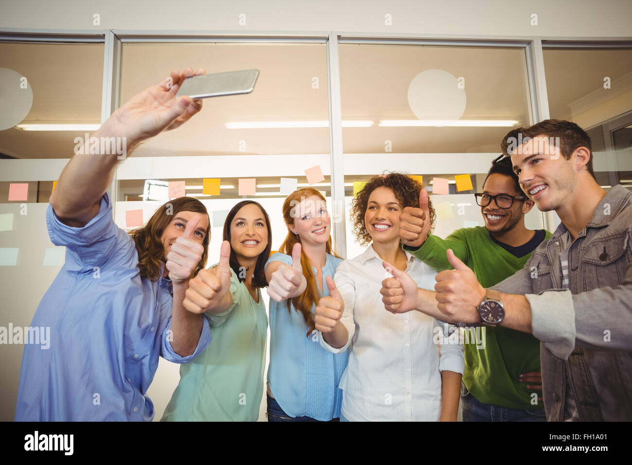 Business people taking selfie with thumbs up Stock Photo - Alamy