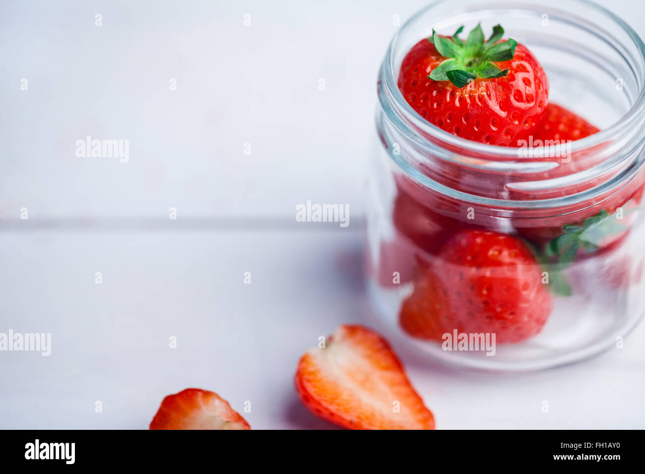 Glass jar of fresh strawberries Stock Photo