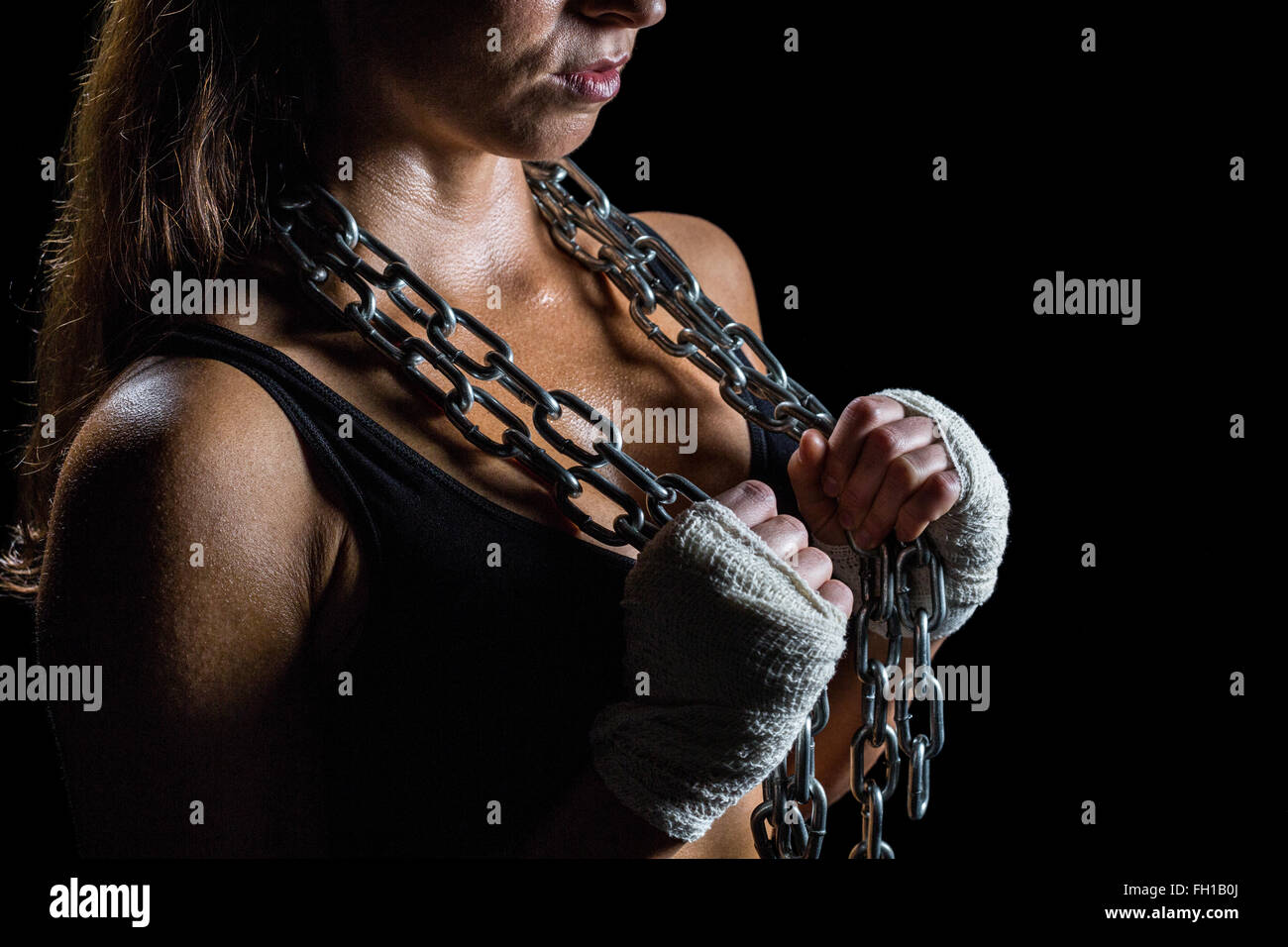 Midsection of female athlete holding chain Stock Photo - Alamy
