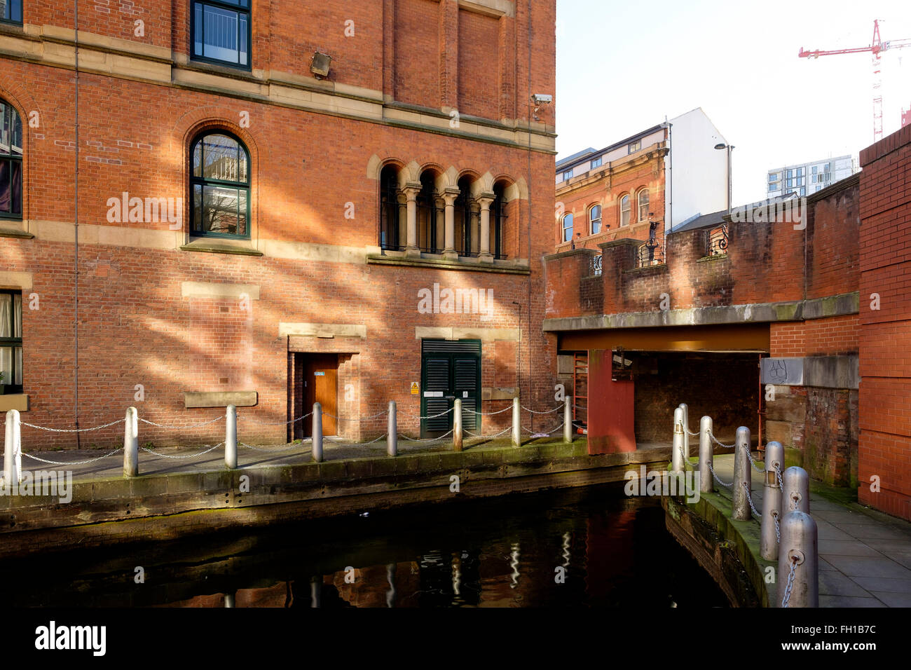 Manchester, UK - 15 February 2016: The narrow entrance through the Great Bridgewater Street to the Barbirolli Square Canal Basin Stock Photo
