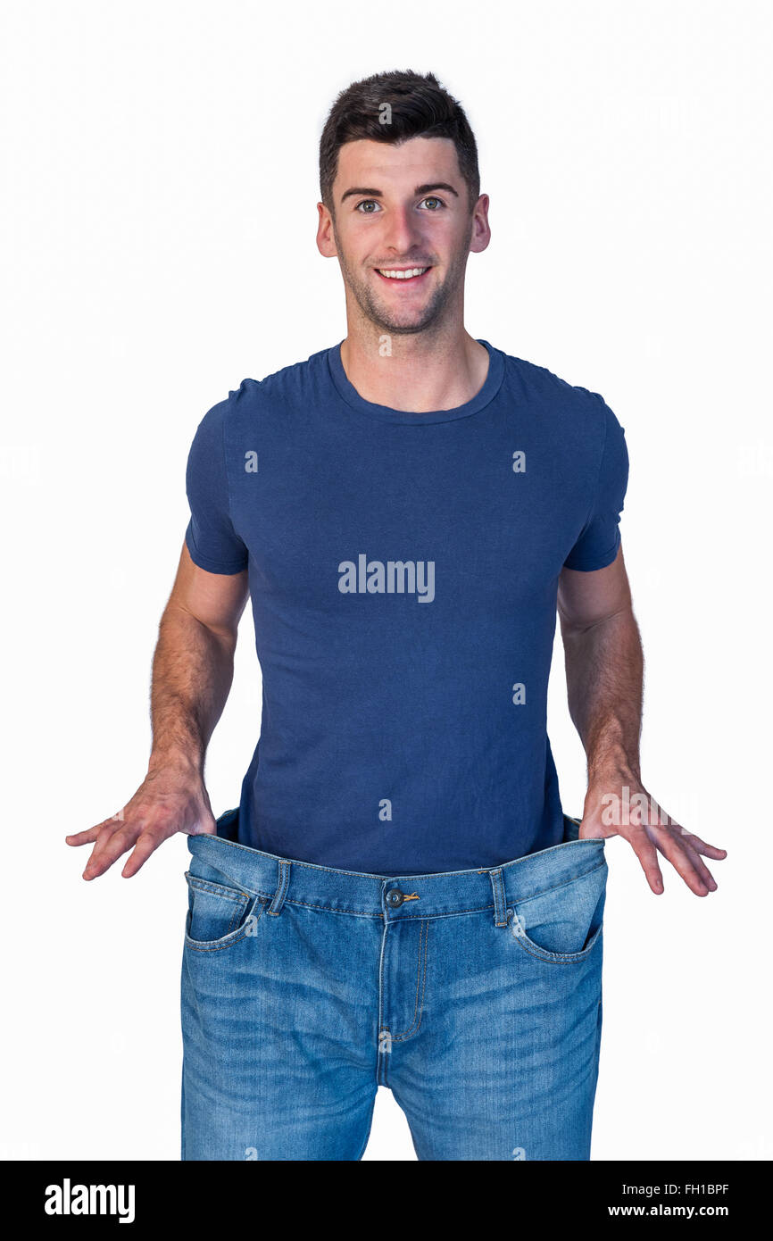 Handsome man showing loose denim jeans Stock Photo