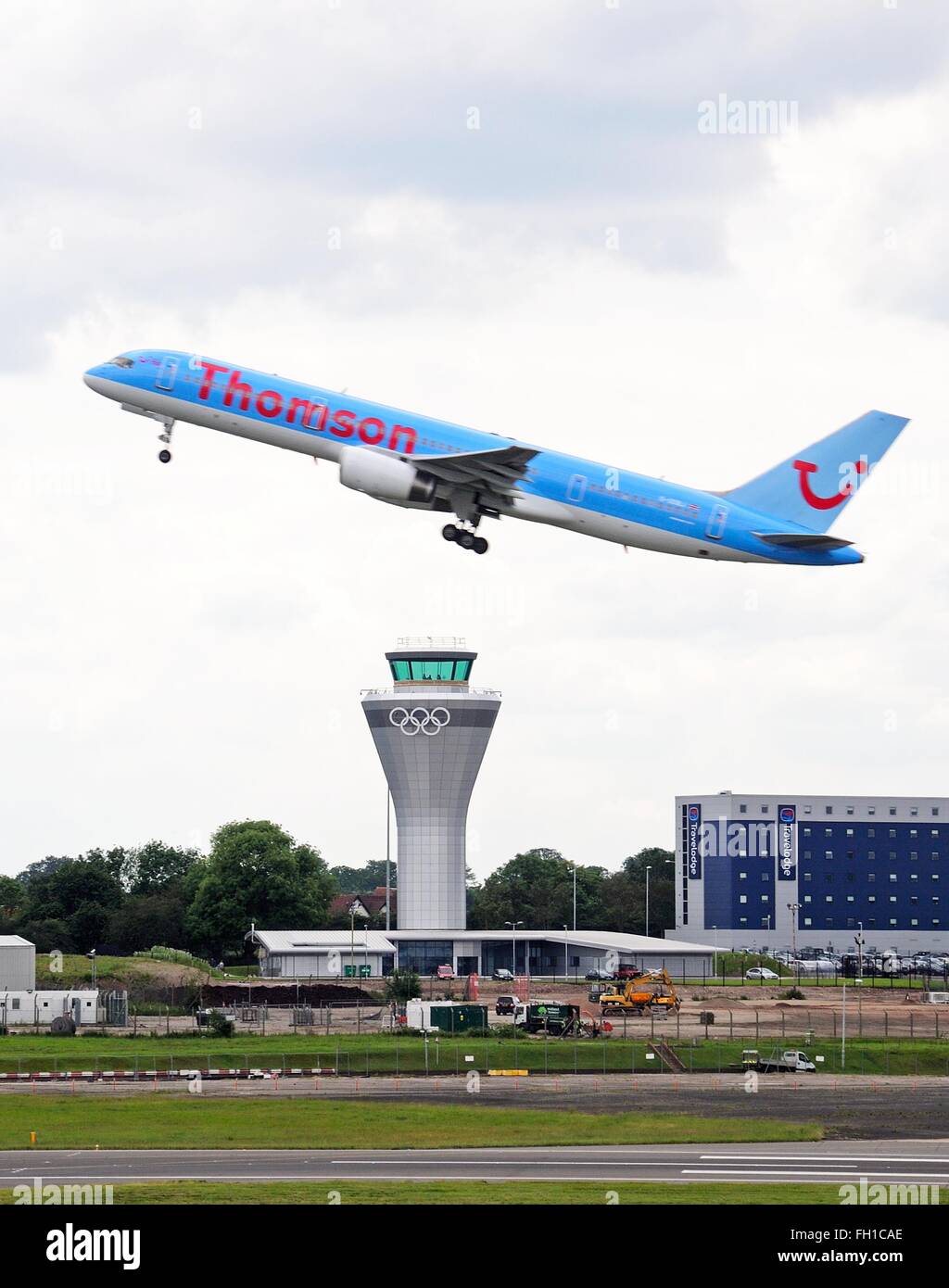 Thomson Airways Boeing 757 200 (G-OOBJ) series taking off over the new control tower at Birmingham Airport, Birmingham, UK Stock Photo