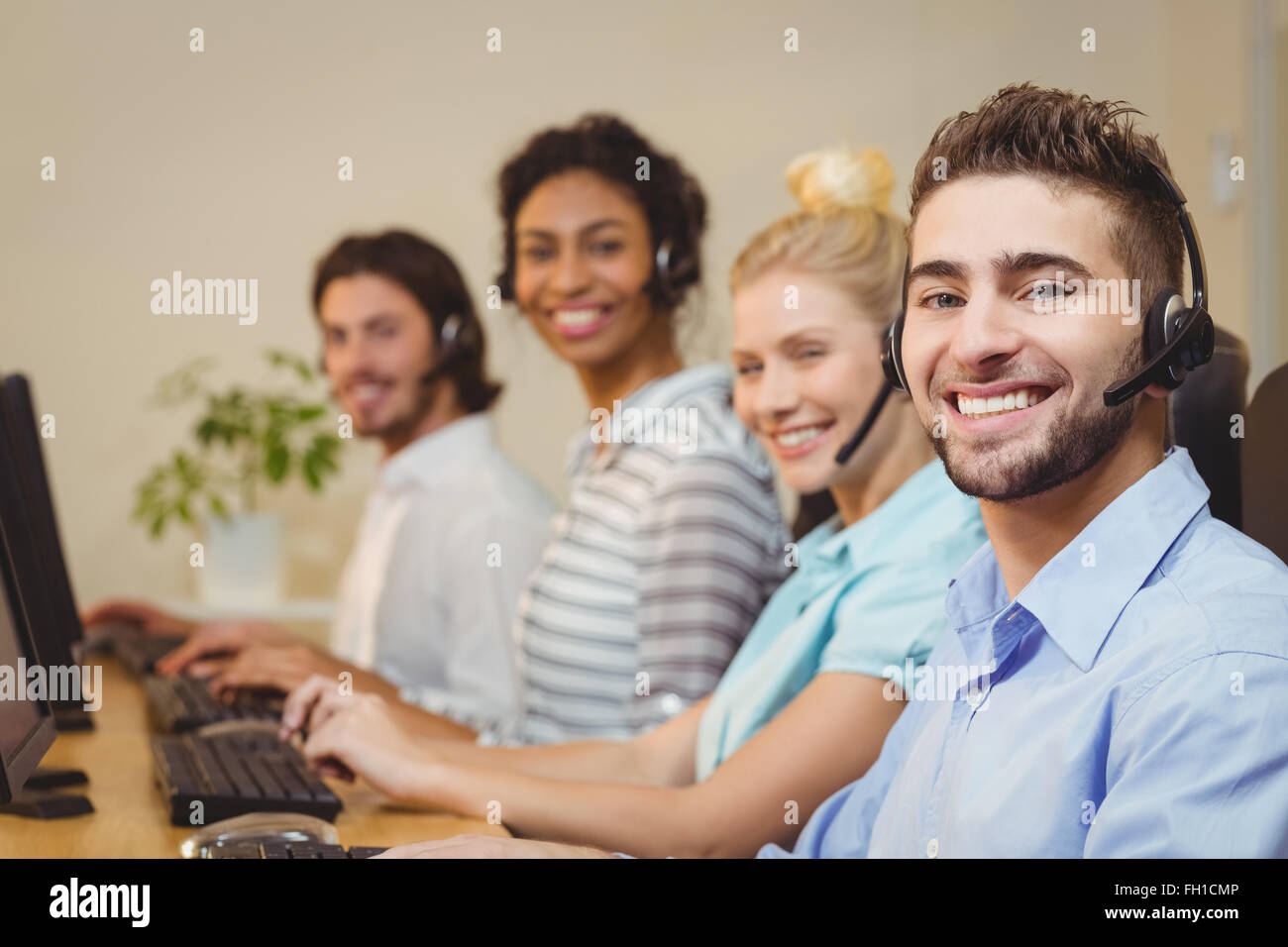 Portrait of smiling business people in call center Stock Photo - Alamy