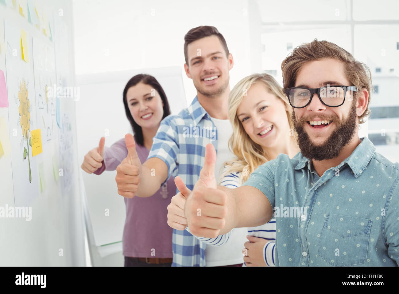 Portrait of smiling business people with thumbs up Stock Photo - Alamy