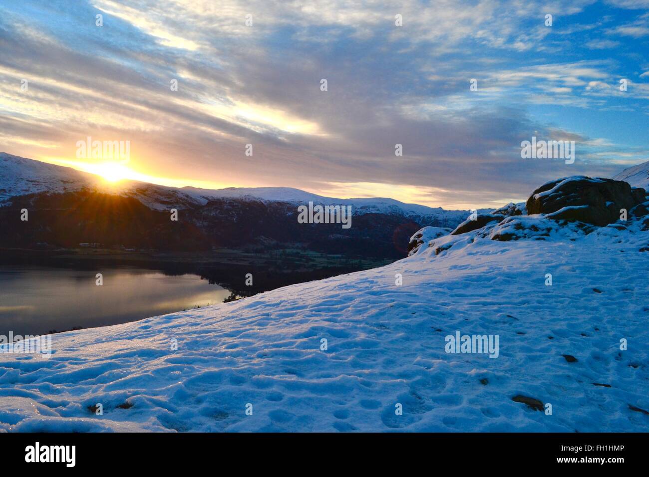 Sunrise over derwentwater in the lake district cumbria, taken from a snow covered catbells Stock Photo