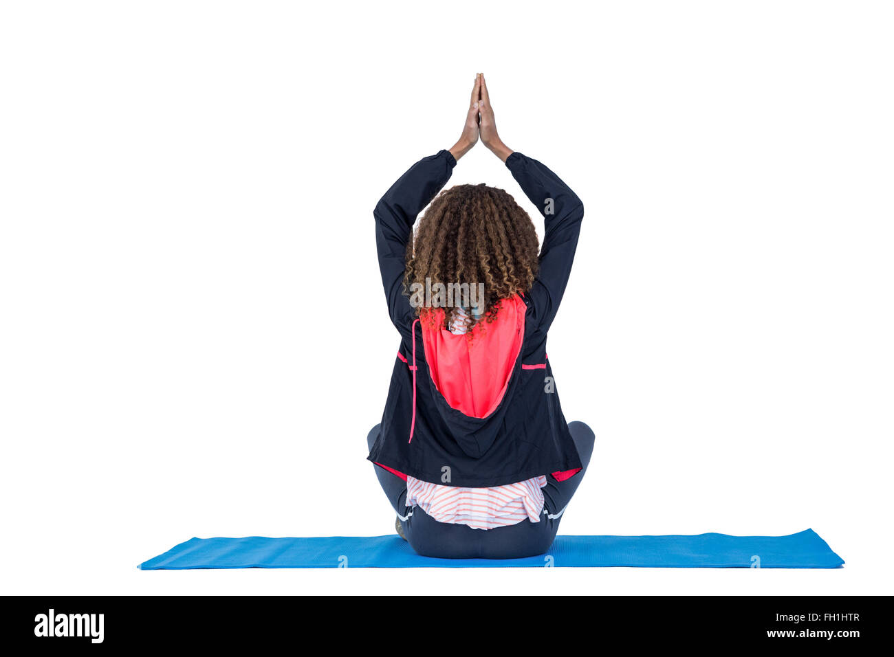 Rear view of woman practicing yoga Stock Photo - Alamy