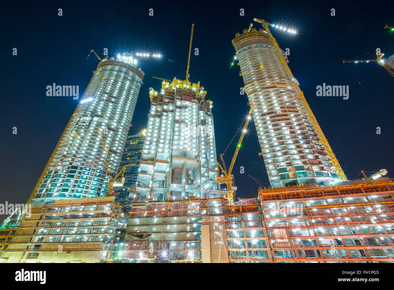 Night view of construction site of new high-rise luxury apartment towers in Dubai United Arab Emirates Stock Photo