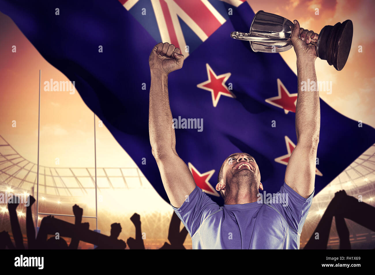 Composite image of happy rugby player holding trophy Stock Photo