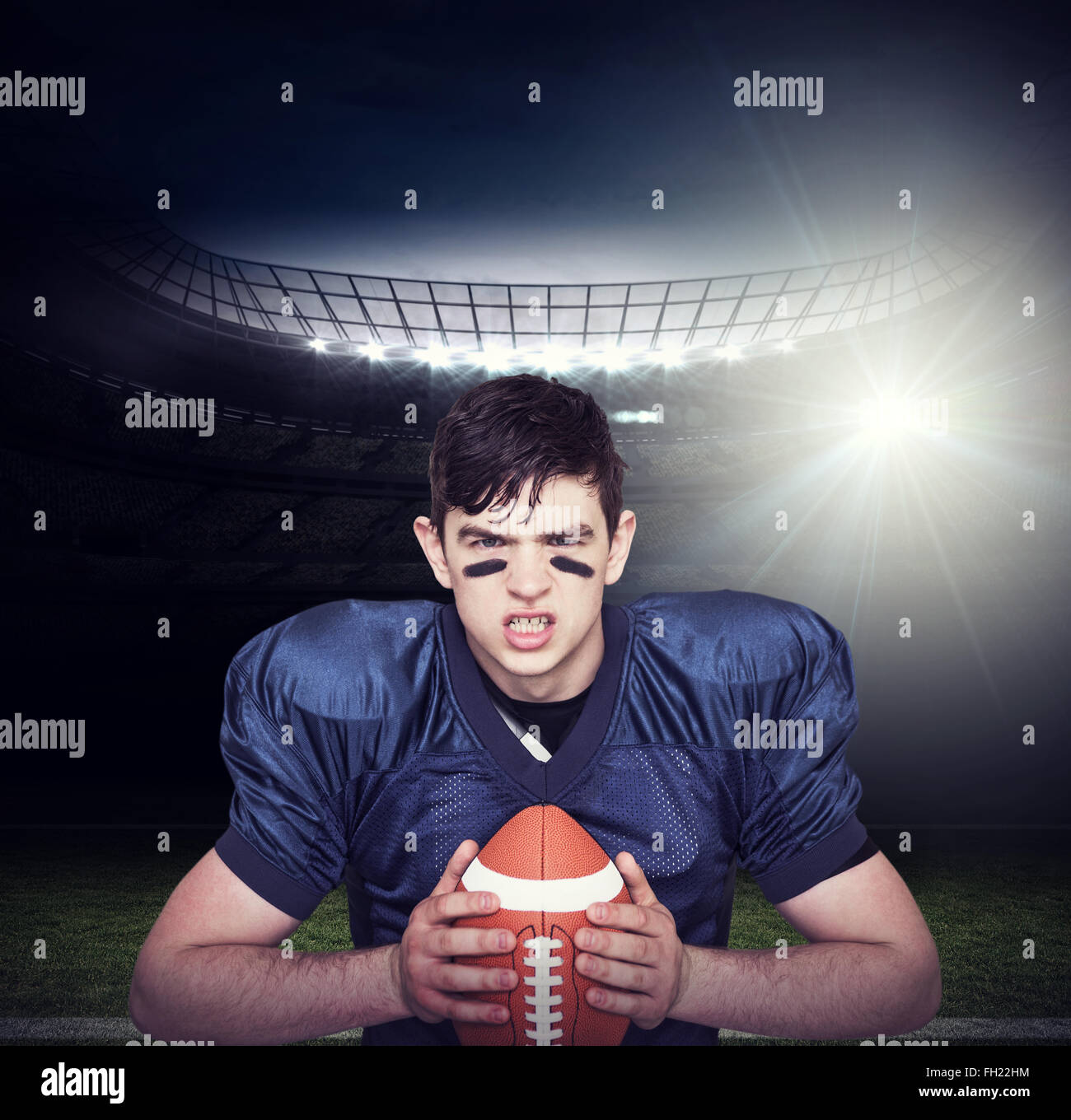 Composite image of enraged american football player holding a ball Stock Photo