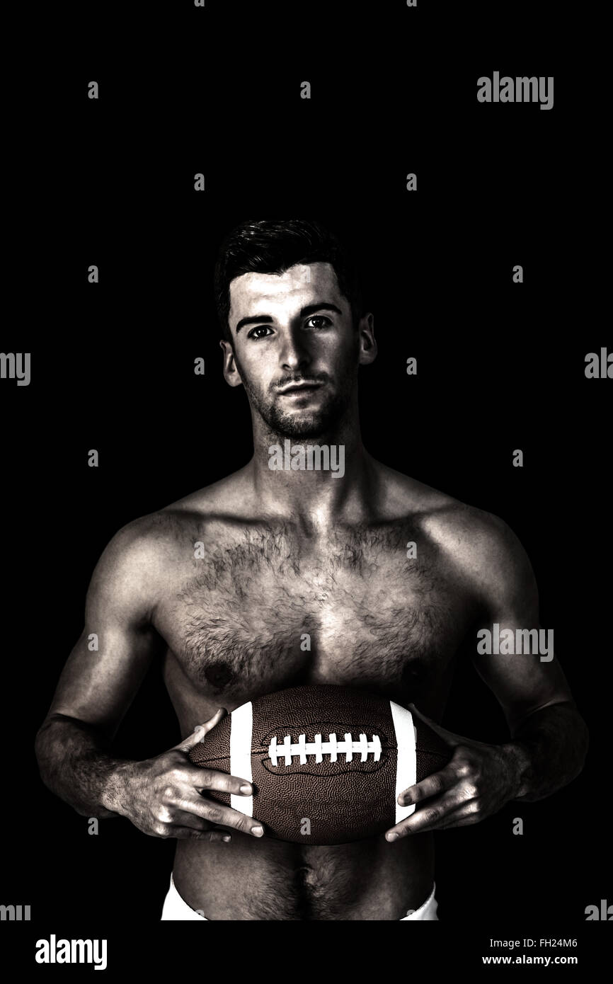 Composite image of portrait of shirtless rugby player with the ball