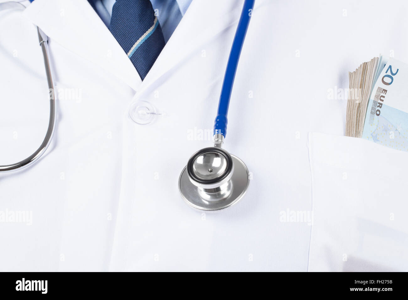 Doctor in white tunic with stethoscope and wad of money in the pocket. Stock Photo