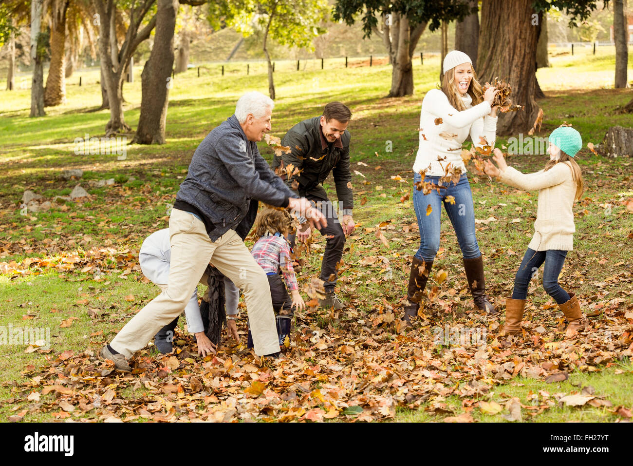 Happy family playing in the park together Stock Photo - Alamy