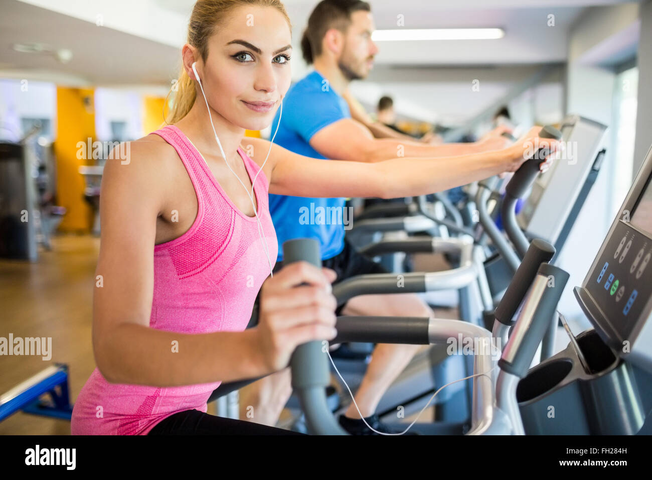 Fit blonde using the step machine Stock Photo - Alamy