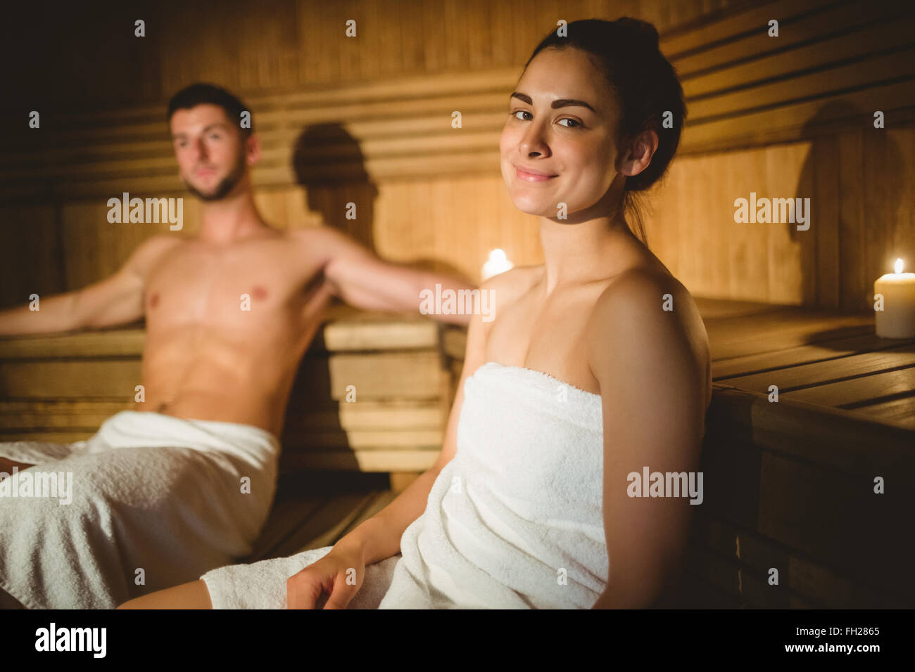Happy couple enjoying the sauna together Stock Photo Alamy