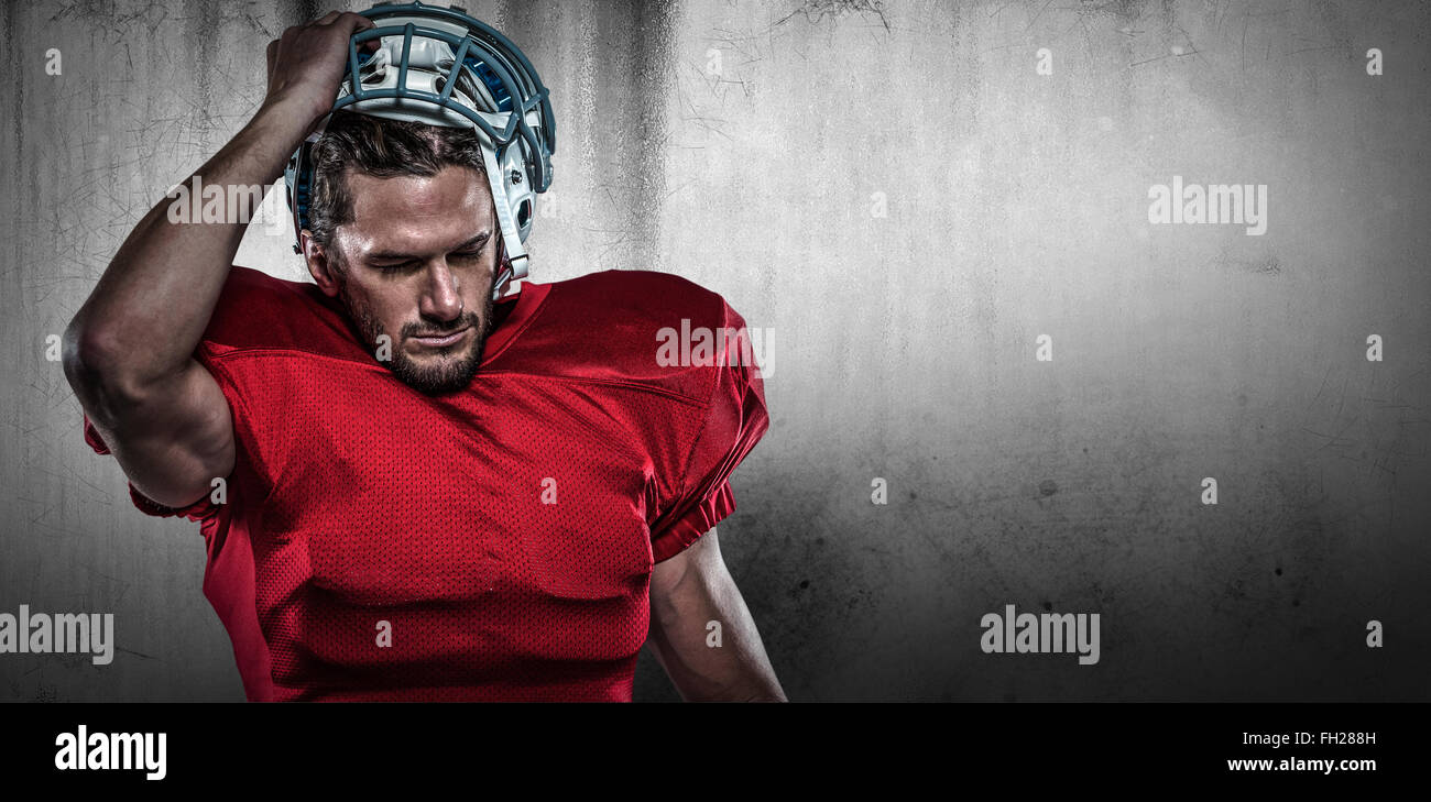 Composite image of american football player in removing helmet Stock