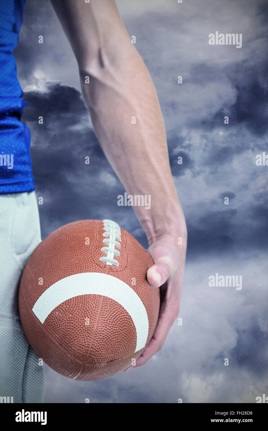 Composite image of midsection of sports player holding ball Stock Photo