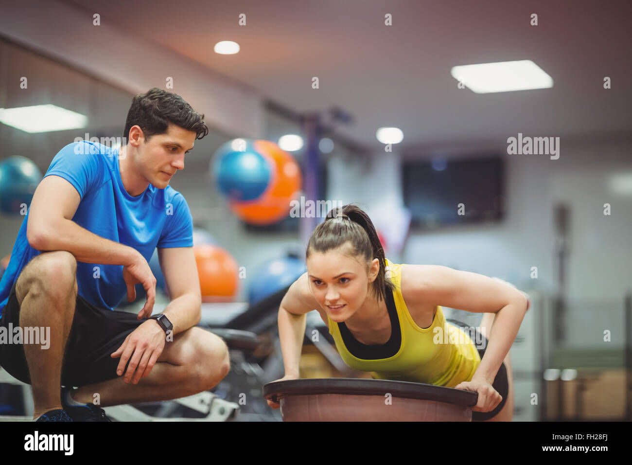 Fit woman working out with trainer Stock Photo Alamy