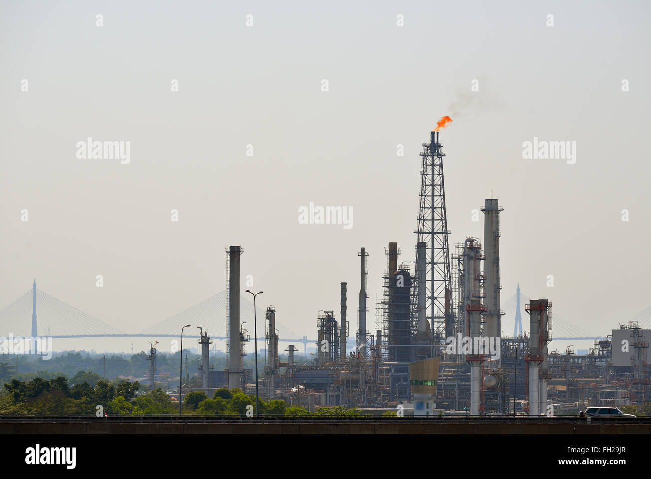 Oil refinery tower with exhausted flame Stock Photo