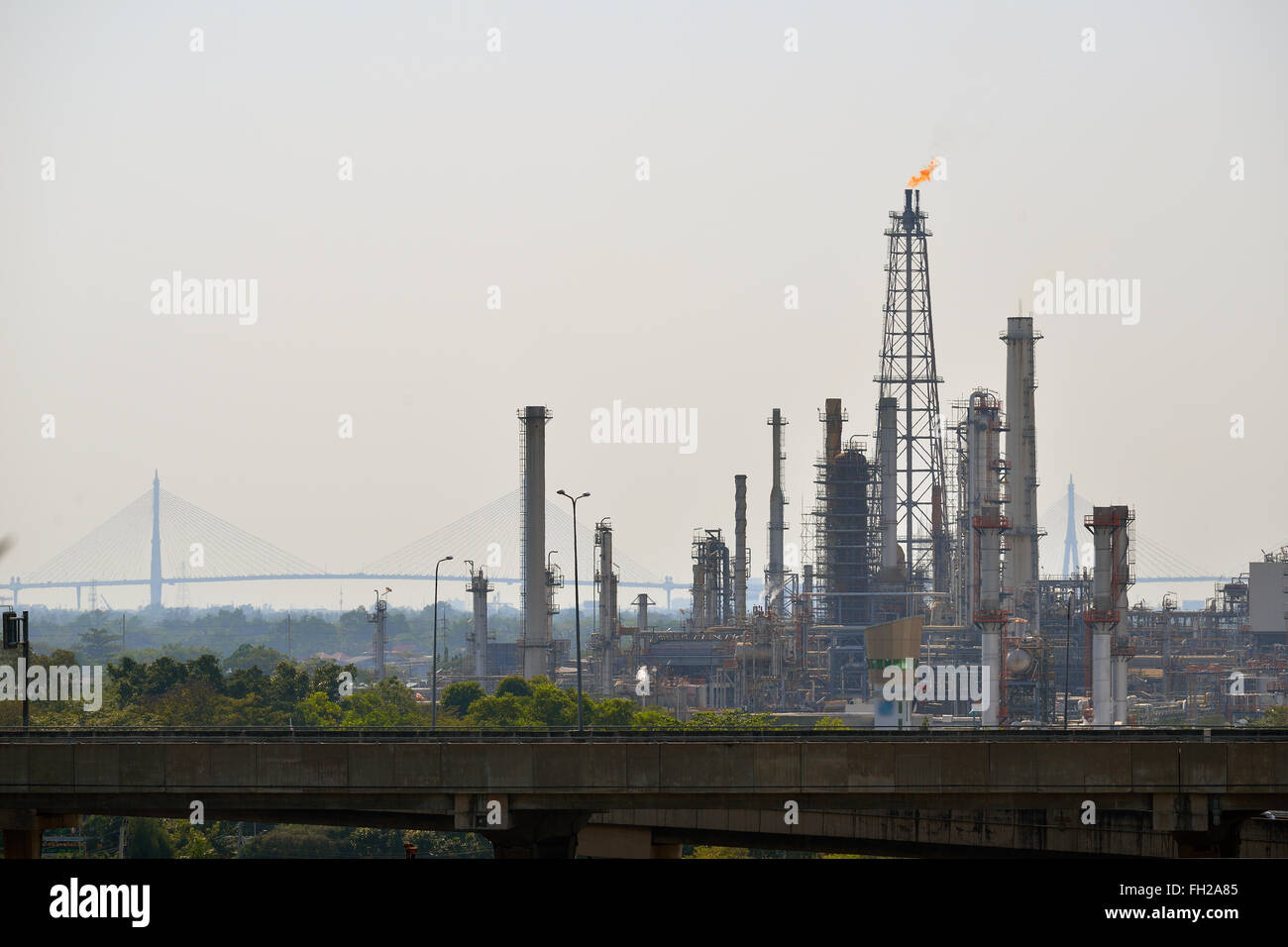 Oil refinery tower with exhausted flame Stock Photo