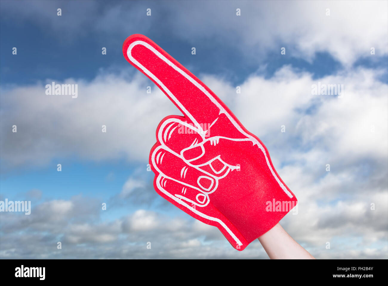 Composite image of american football player holding supporter foam hand Stock Photo