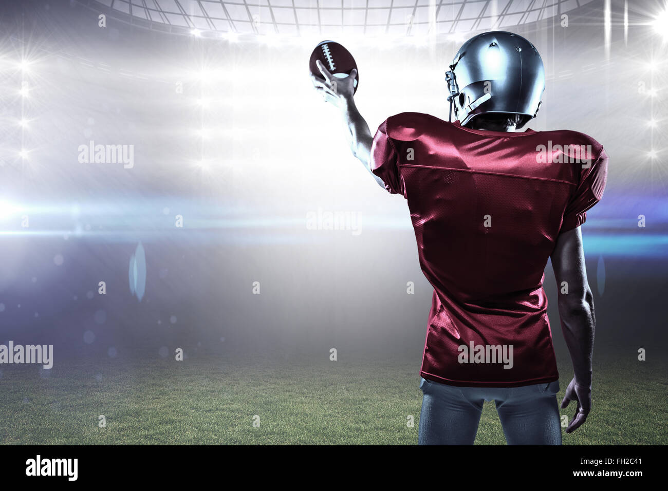 Composite image of rear view of sport player in red jersey holding ball Stock Photo