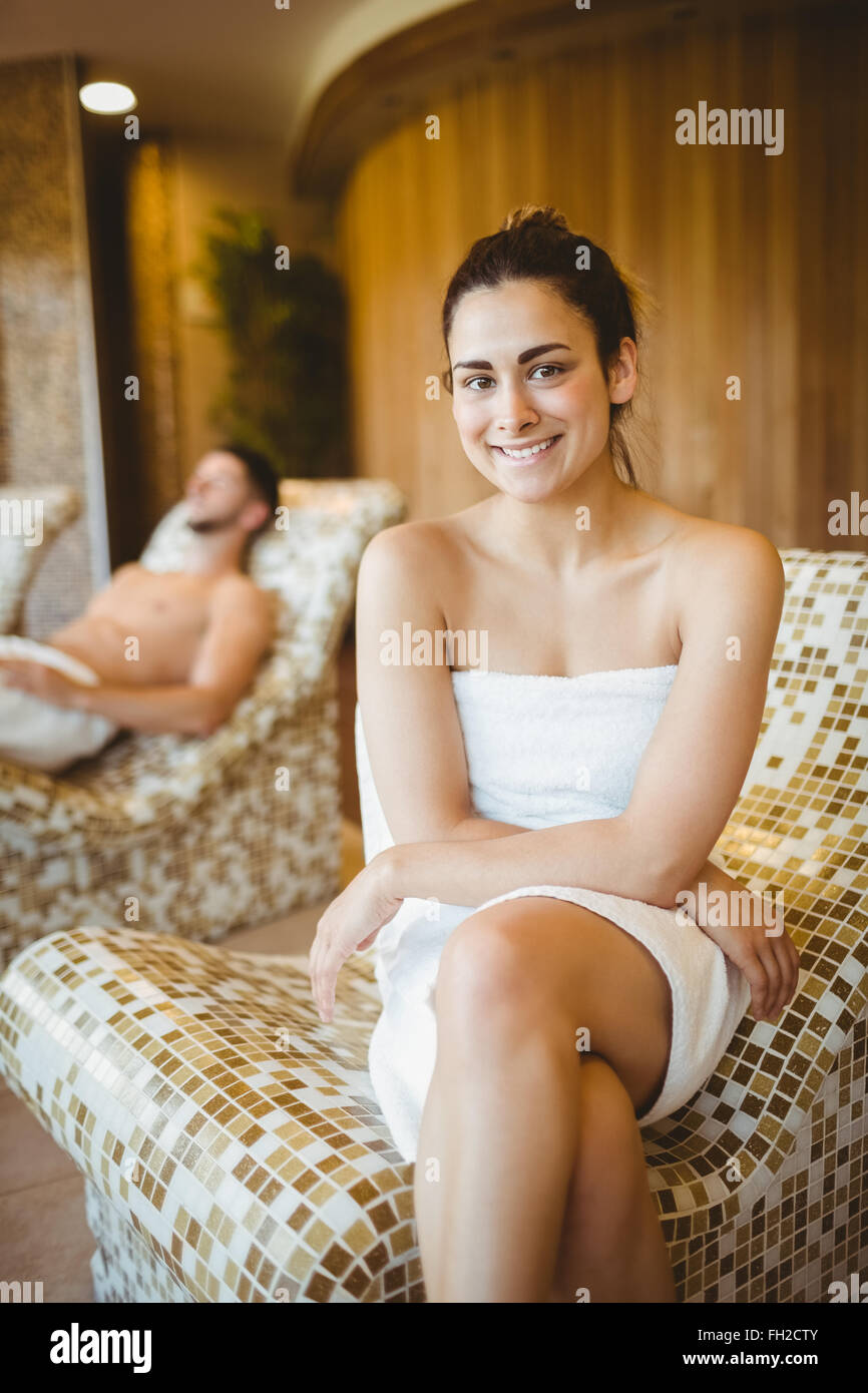 Smiling woman sitting on a chair Stock Photo - Alamy