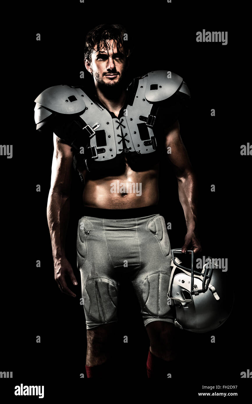 Composite image of shirtless american football player with padding