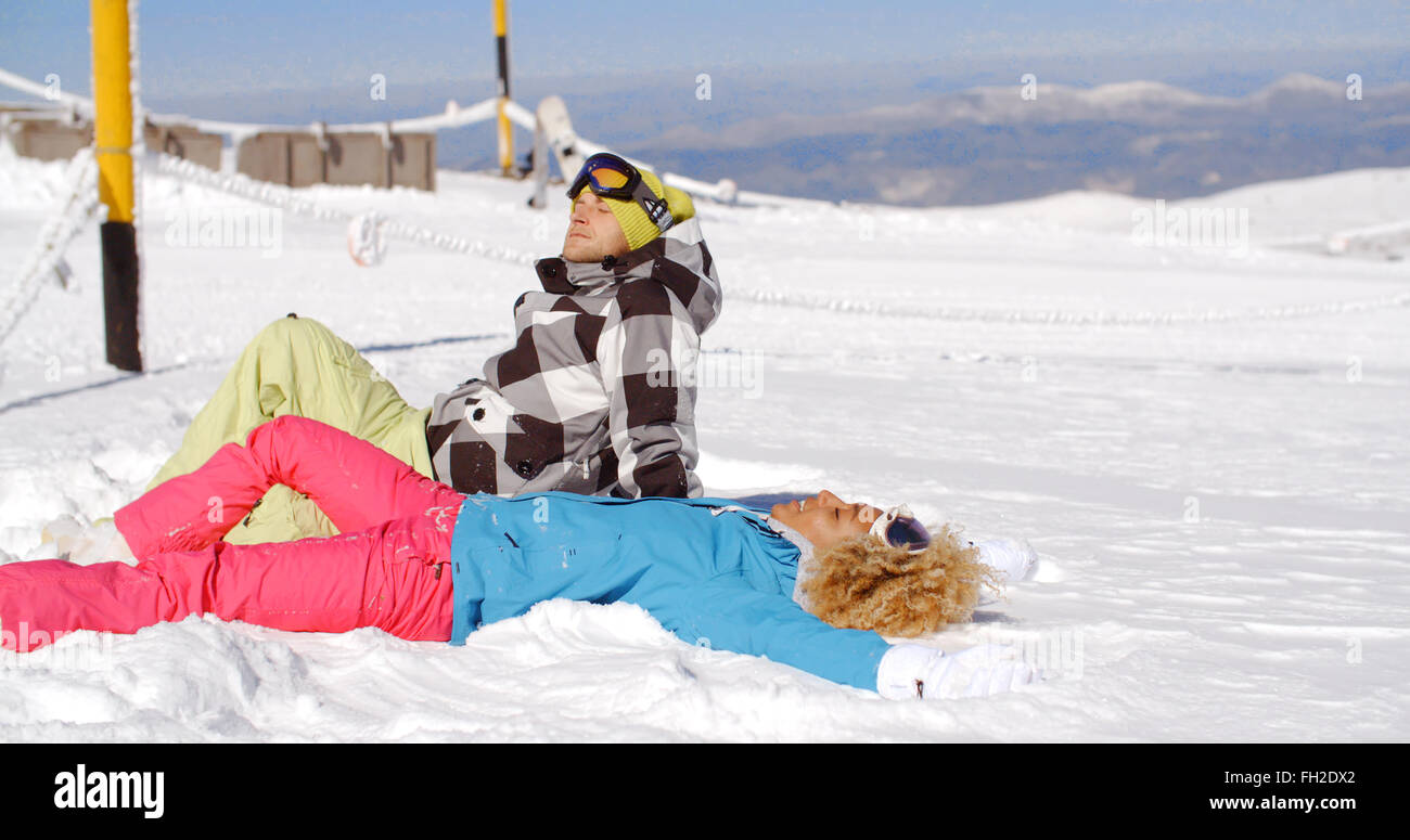 Premium Photo  Cute woman skier sitting on the top of the snowy