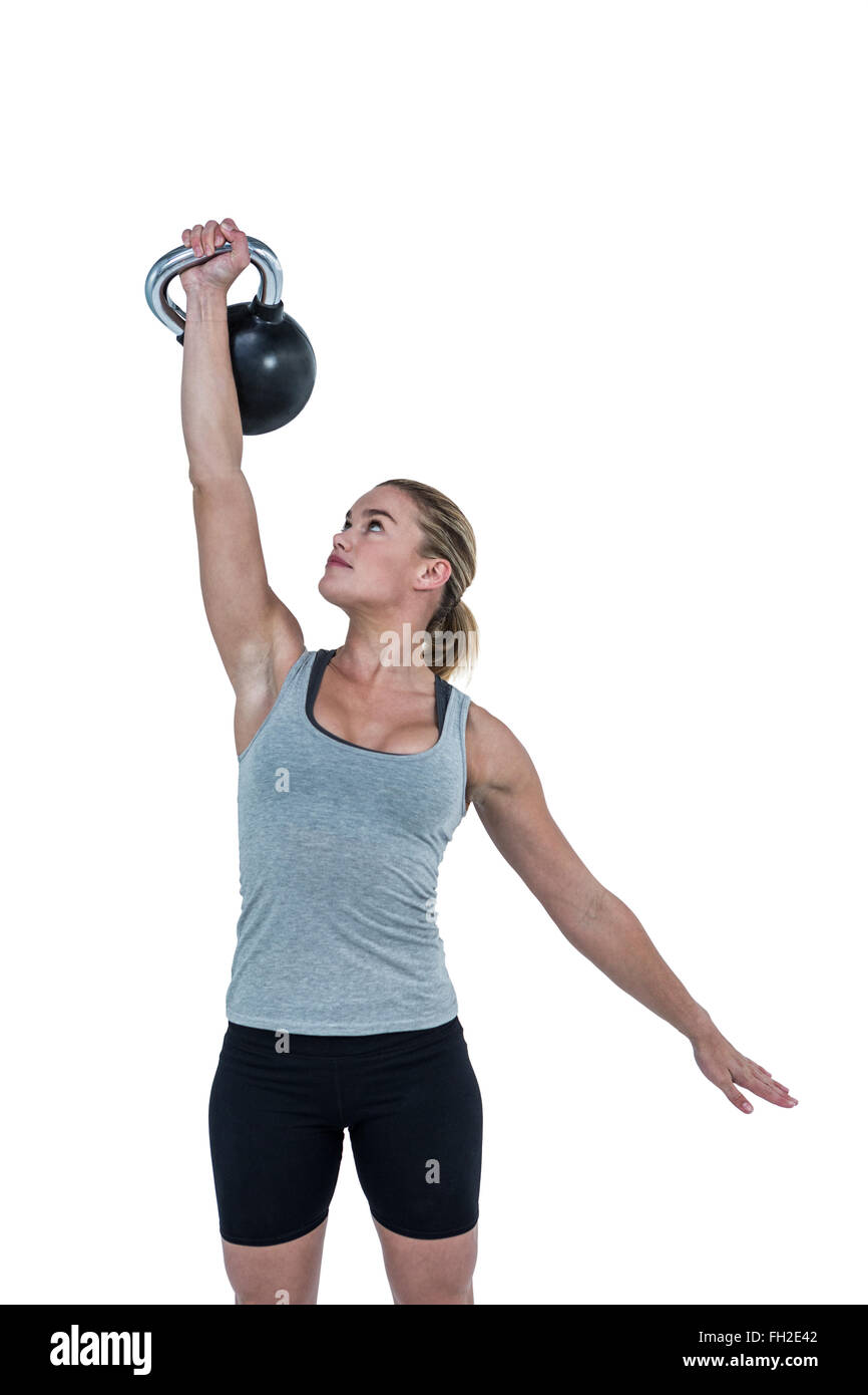 Serious muscular woman lifting kettlebell Stock Photo Alamy
