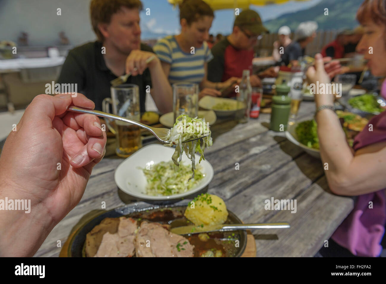 Hikers enjoying a lunchtime meal at a mountain hut. Kitzbüheler Alps. Kitzbühel, Austria. Europe Stock Photo