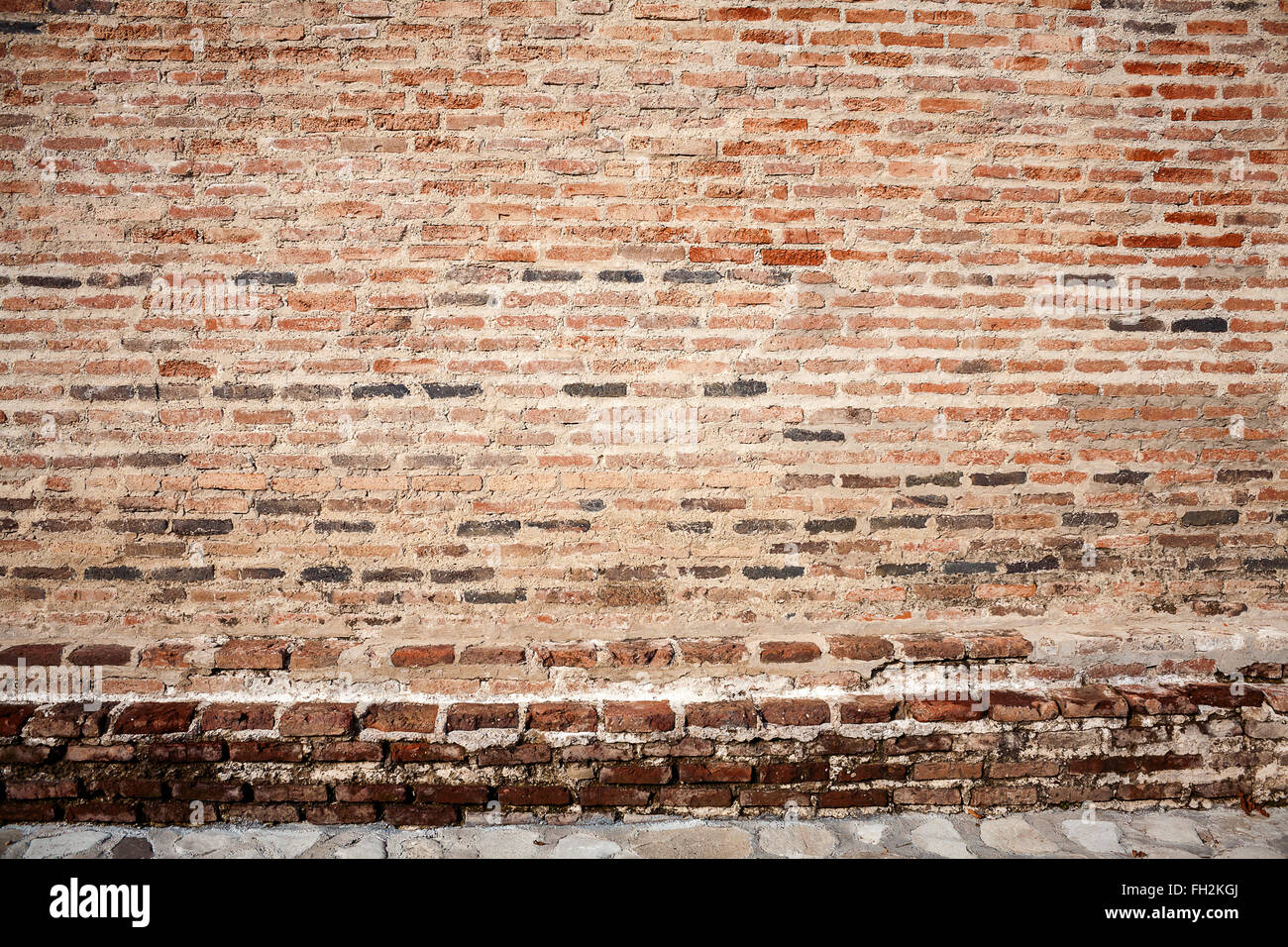 Red brick wall background with stone basement Stock Photo Alamy