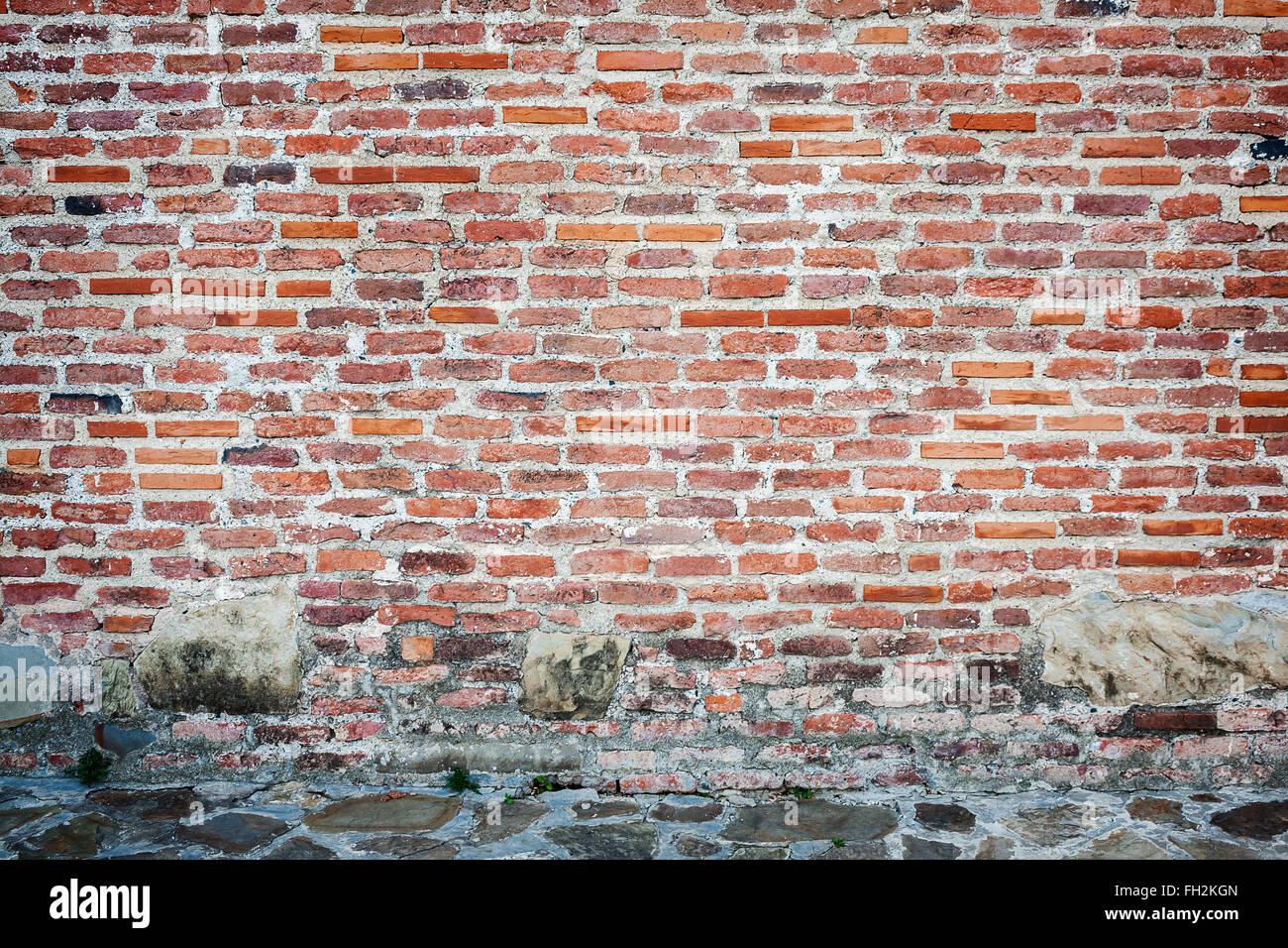 Red brick wall background with stone basement Stock Photo Alamy