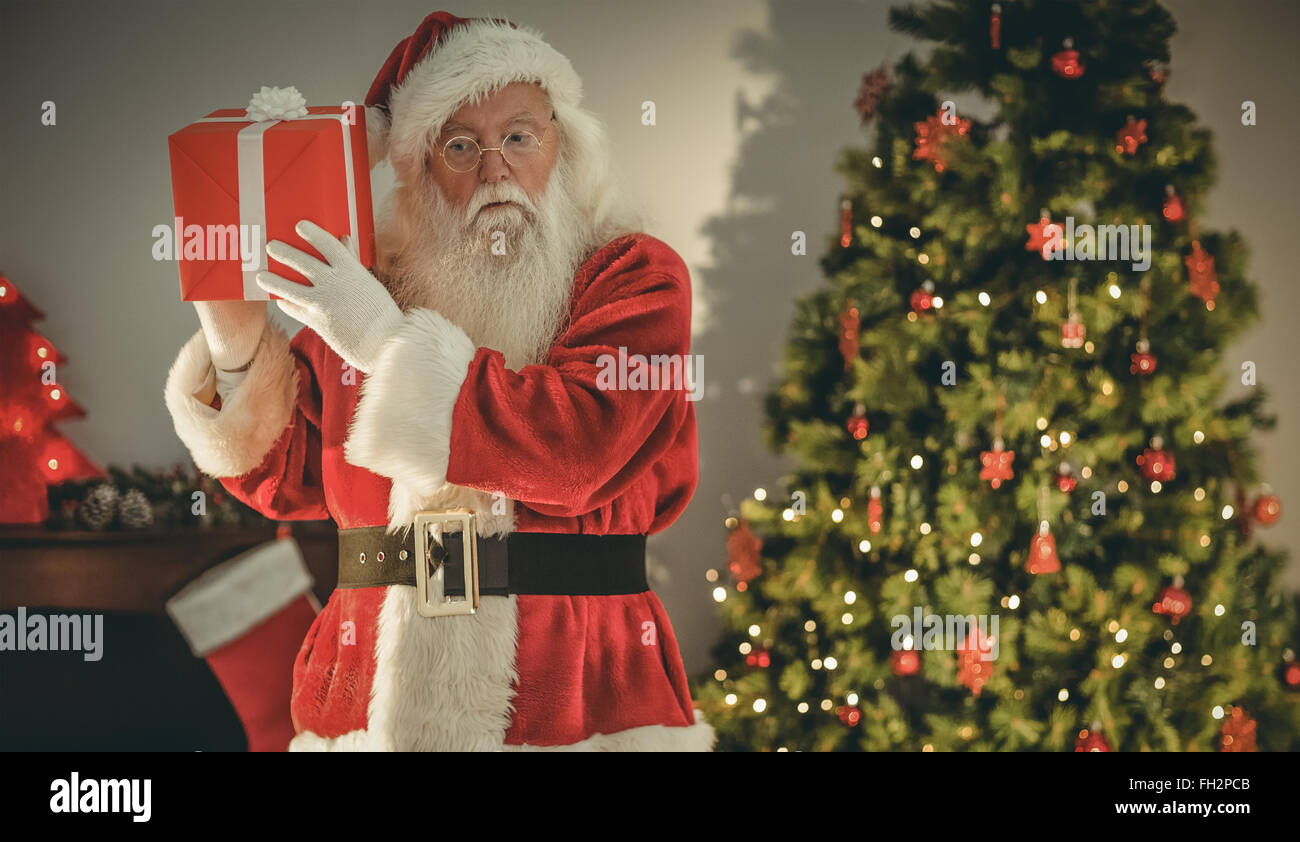 Father christmas delivering gift at christmas eve Stock Photo Alamy