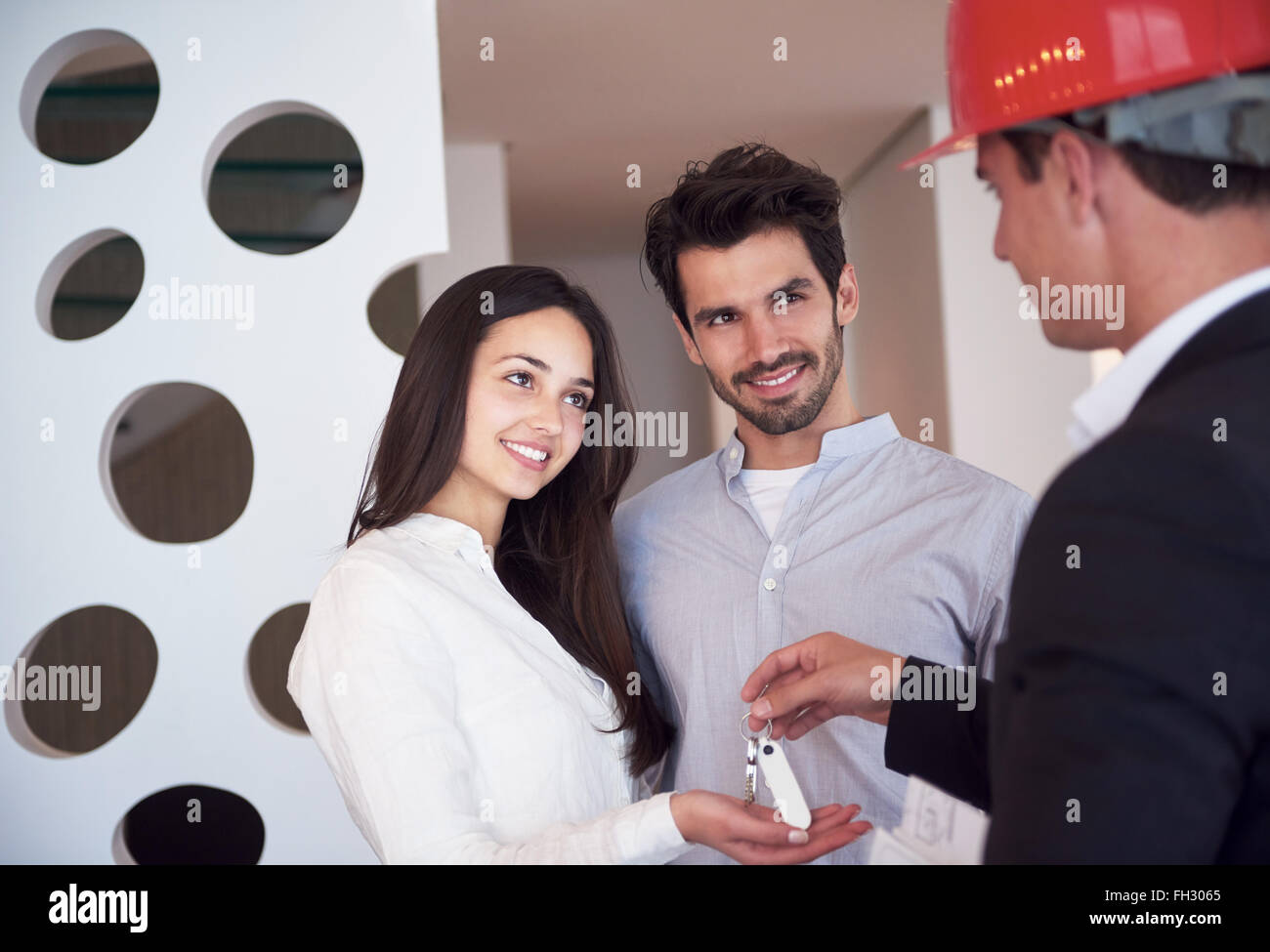couple buying new home with real estate agent Stock Photo Alamy
