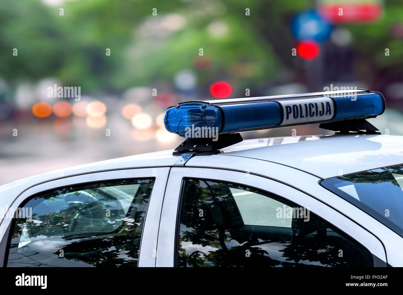 Police officer emergency service car driving street Stock Photo