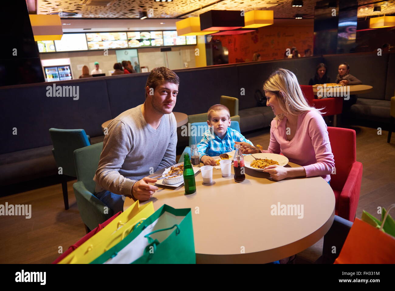 family having lunch in shopping mall Stock Photo