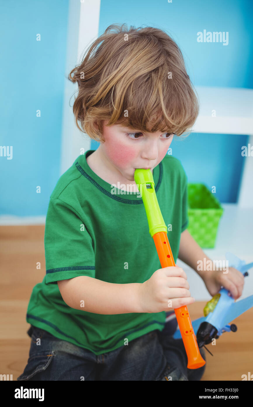 Small boy playing the flute Stock Photo