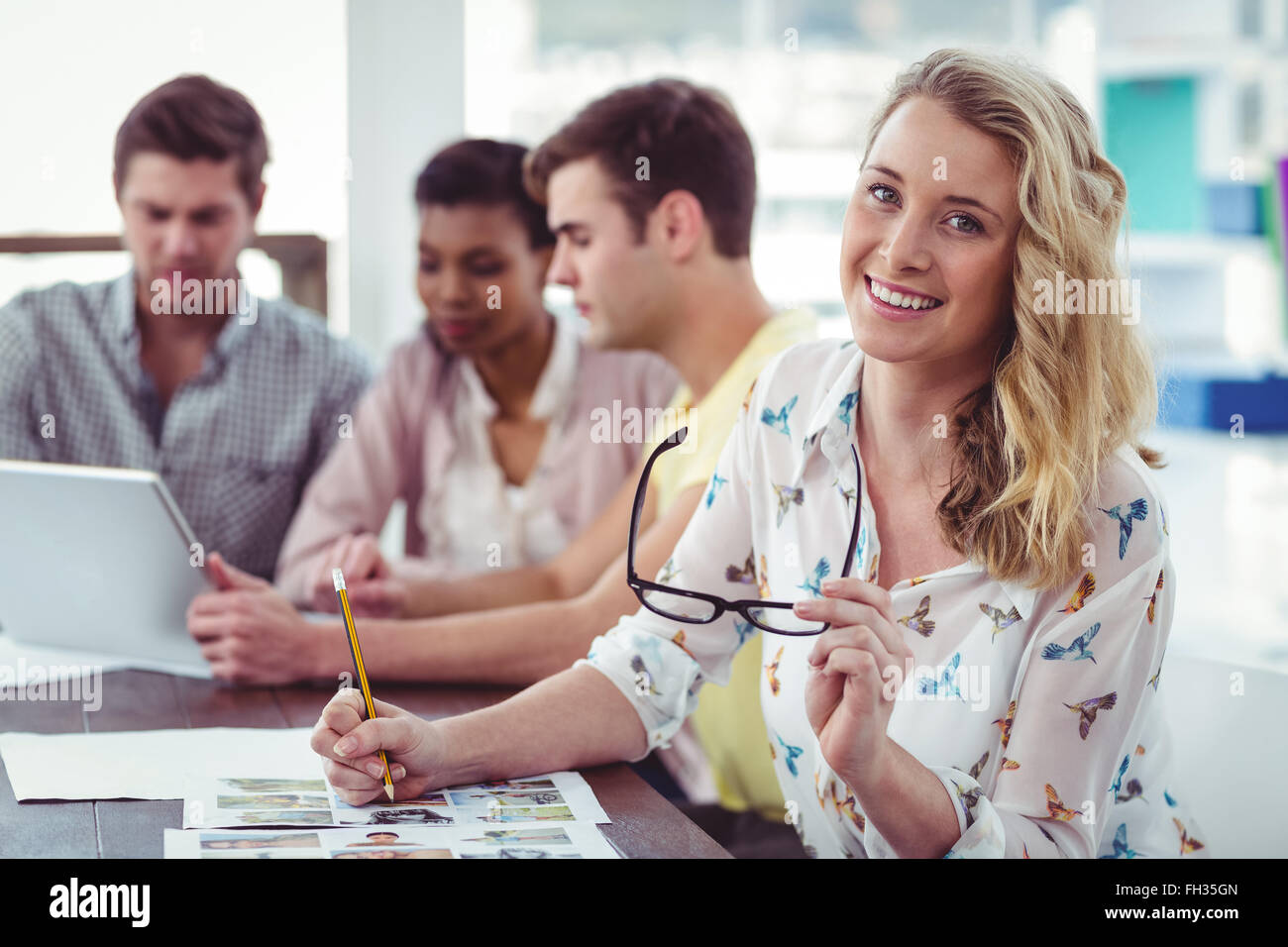 Creative business team working on a laptop together Stock Photo - Alamy