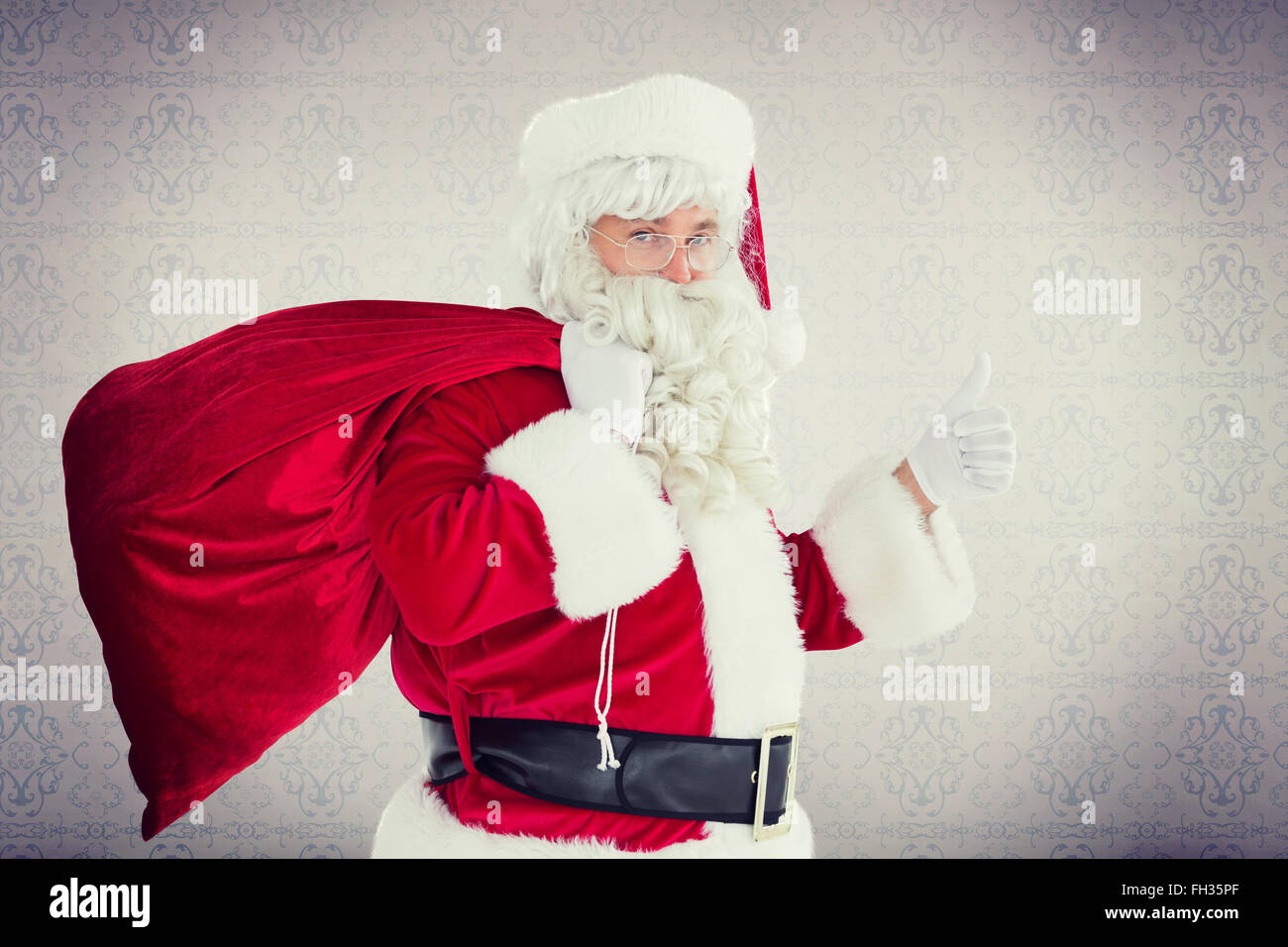 Composite image of positive santa with his sack and thumbs up Stock ...