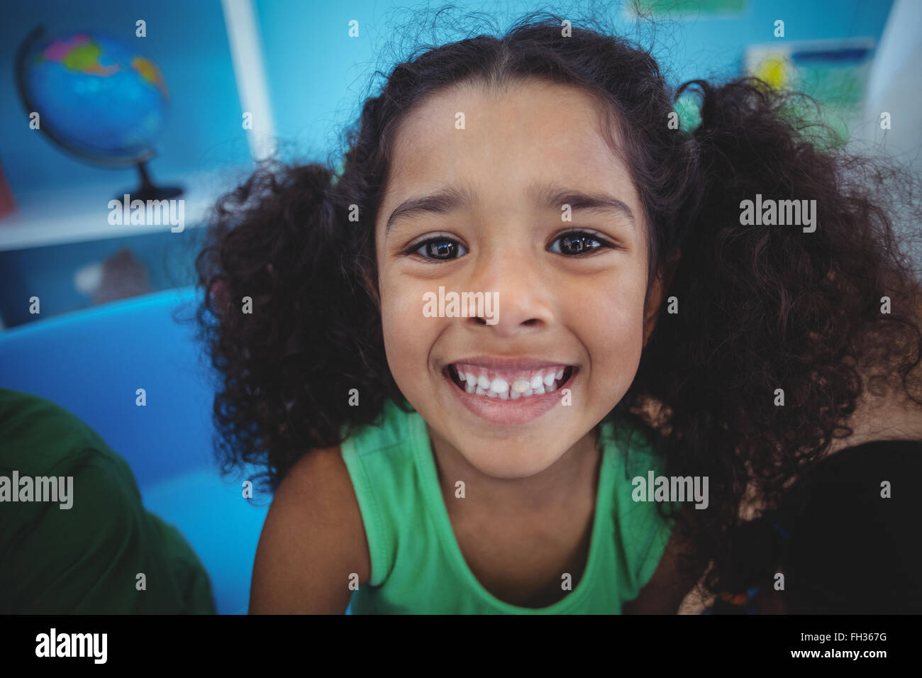 Smiling girl looking at the camera Stock Photo - Alamy