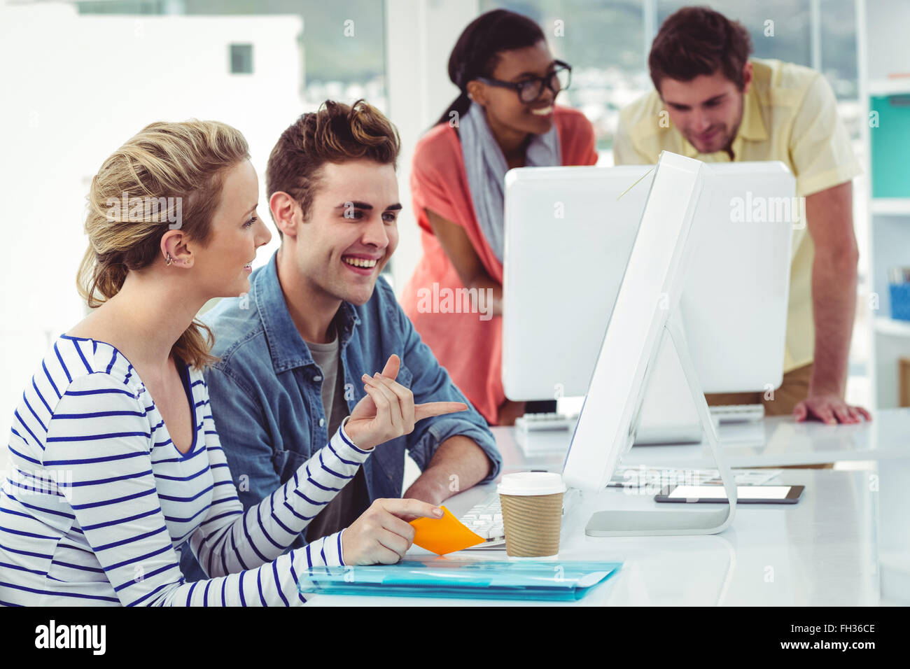 Creative business team working hard together on pc Stock Photo - Alamy