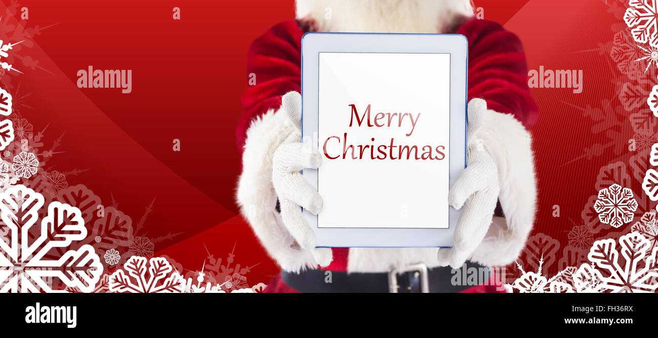 Composite image of santa presents a tablet pc Stock Photo - Alamy