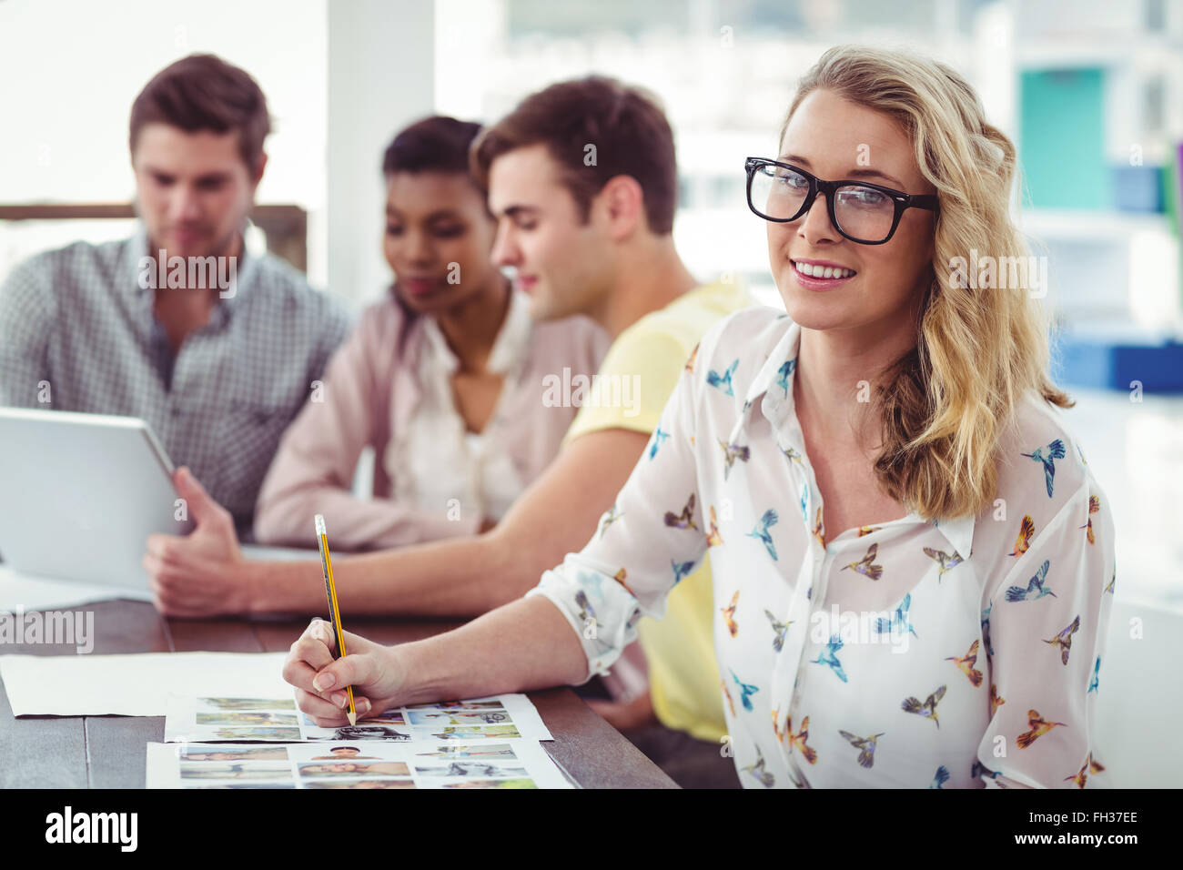 Creative business team working on a laptop together Stock Photo - Alamy