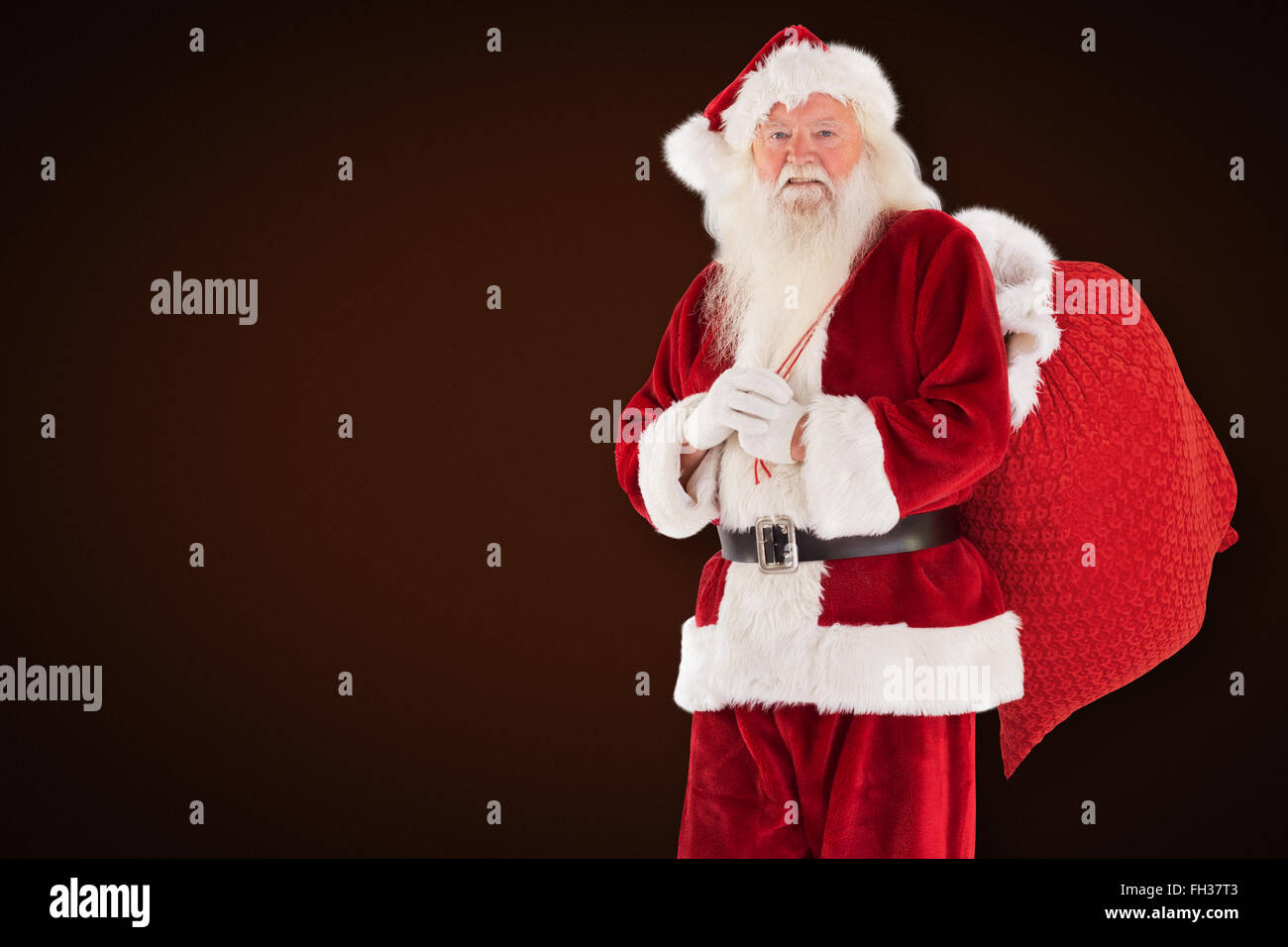 Composite image of santa carries his red bag Stock Photo - Alamy