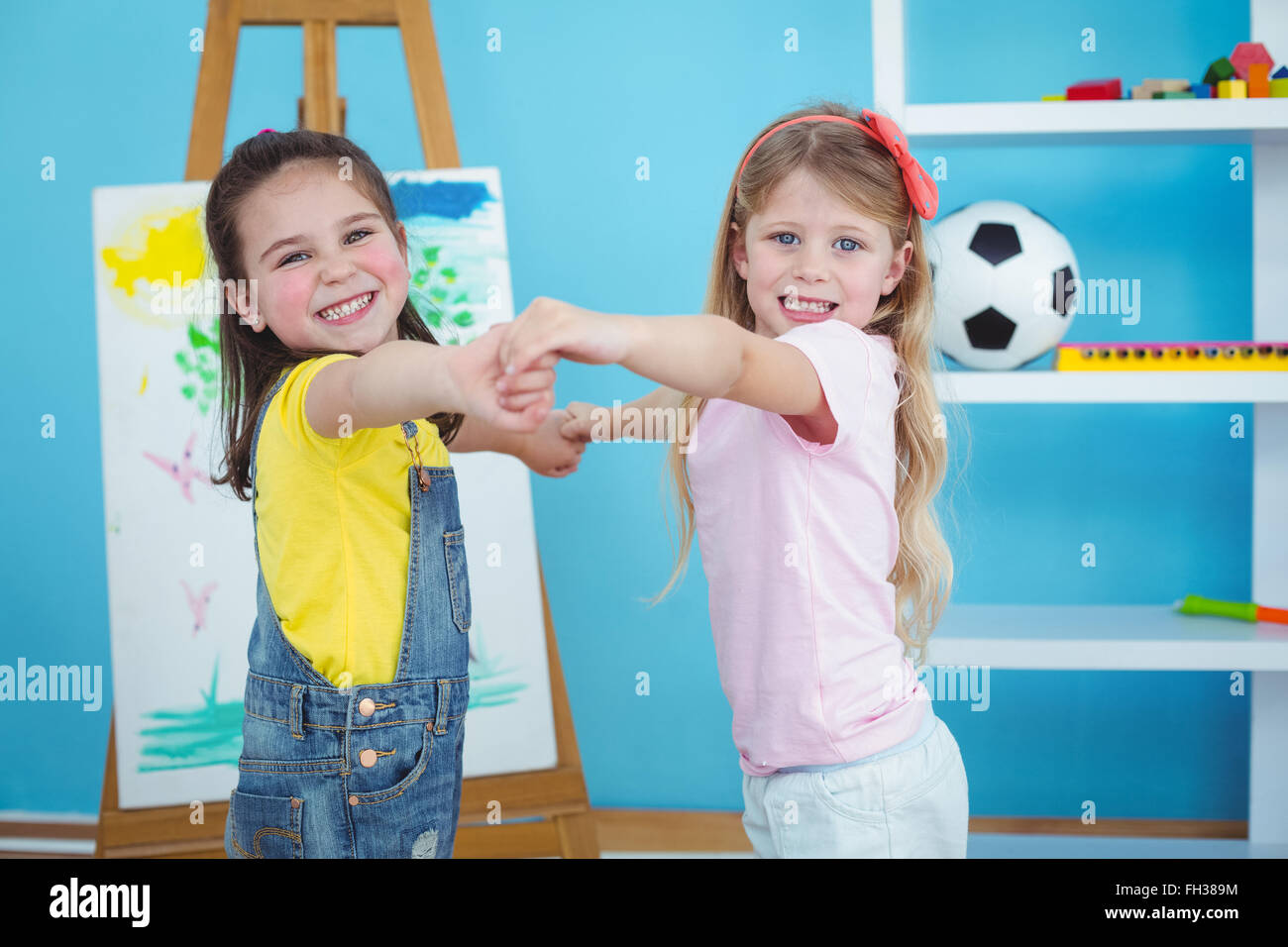 Happy kids holding hands Stock Photo - Alamy