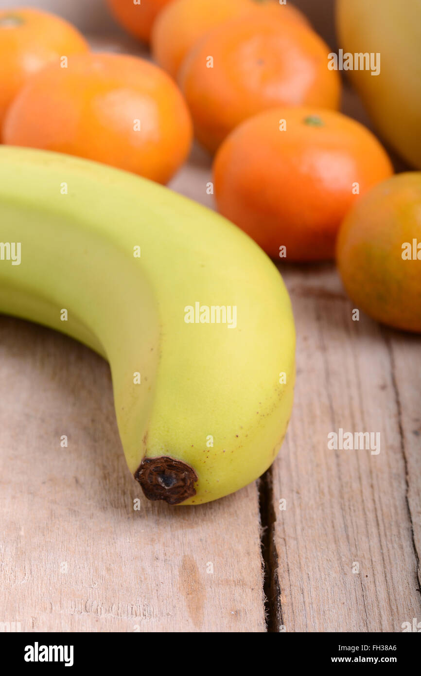 Fresh colorful fruits composition mandarin, bananas and orange Stock